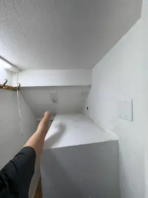 Under-stair closet with new drywall taped, textured and ready for flooring