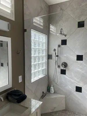 Finished walk-in shower with a glass block window
