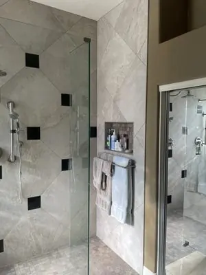 Finished walk-in shower with a fixed glass panel